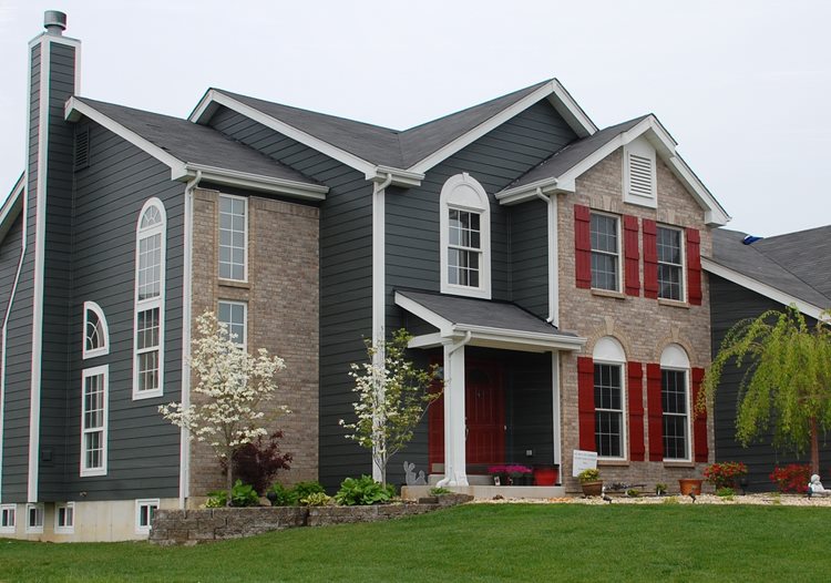 A darker siding and brick combination, with dark gray siding and a dark beige brick color.