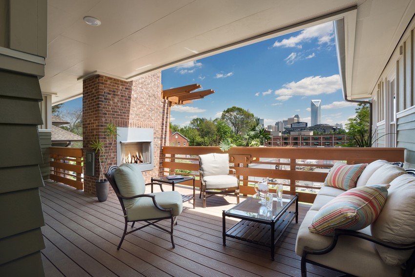 Wooden-Deck-With-White-Outdoor-Furniture-And-Small-Electric-Fire-Pit