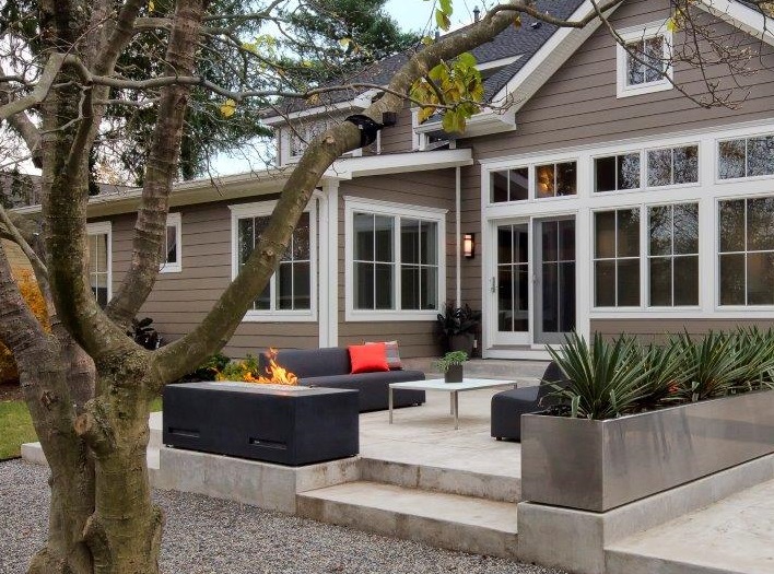 Khaki-Brown-James-Hardie-Fiber-Cement-Siding-With-White-Marble-Deck-Black-Outdoor-Firepit-And-Furniture