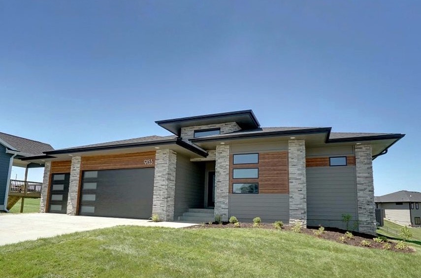 modern design example with lap siding and stone accents