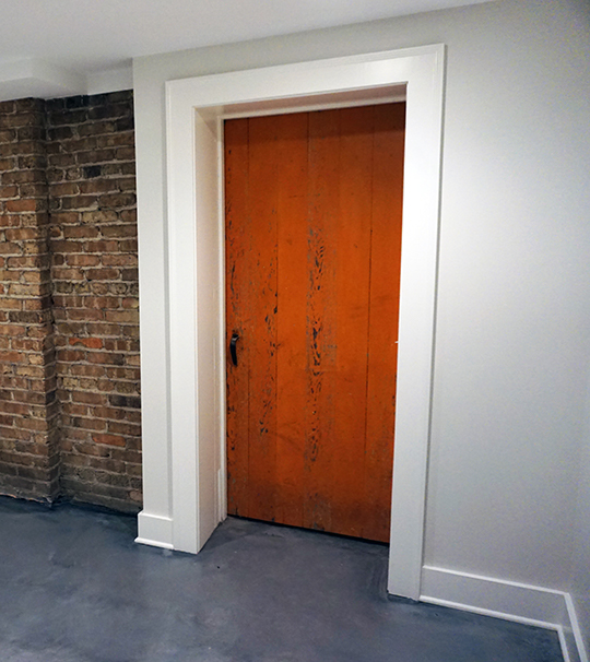 Pristine-White-Walls-Surrounding-Old-Wooden-Red-Door