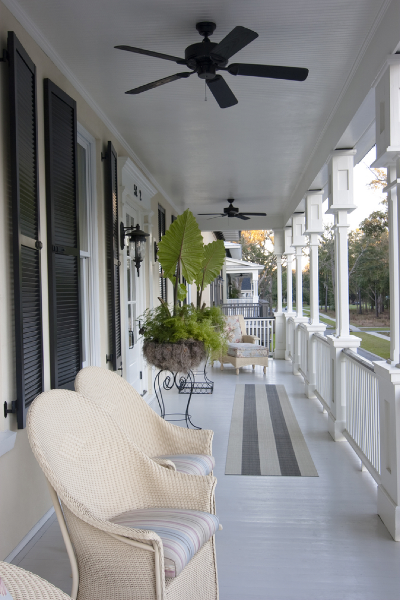 White-Porch-With-Black-Window-Shutters-And-White-Chairs